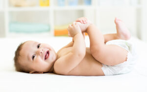 Smiling baby during diaper change, natural zinc-free protection for diaper rash